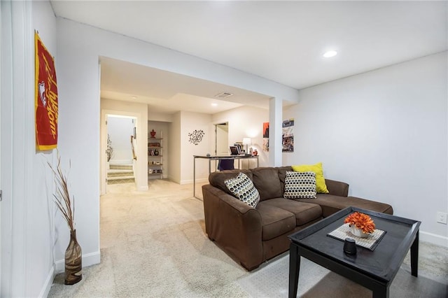 living area featuring light carpet, stairs, baseboards, and recessed lighting