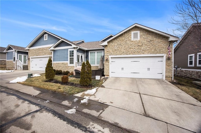 view of front of property featuring concrete driveway, stone siding, and an attached garage