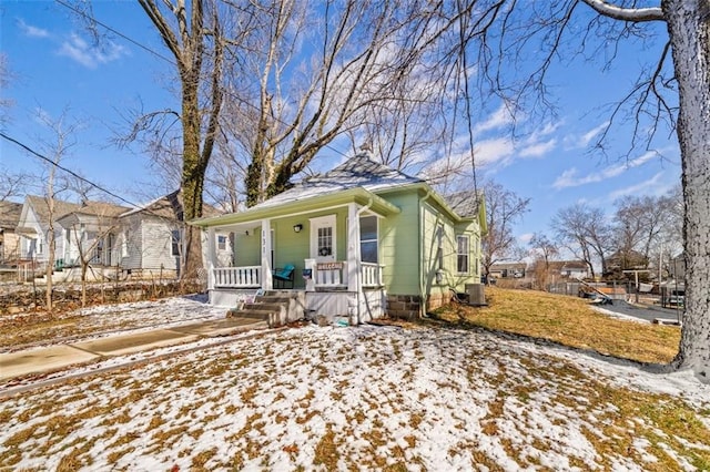 bungalow-style house featuring covered porch and central AC