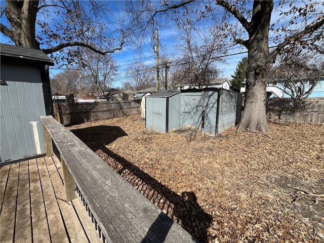 view of yard featuring an outbuilding, a shed, and a fenced backyard