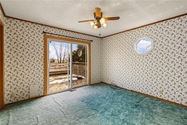 empty room with plenty of natural light, a textured ceiling, ornamental molding, and wallpapered walls