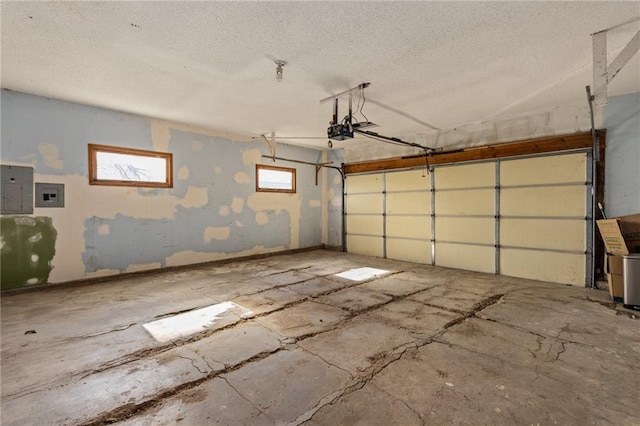 garage featuring electric panel and a garage door opener