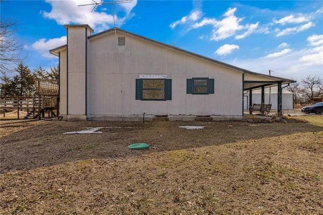 view of side of home with a carport