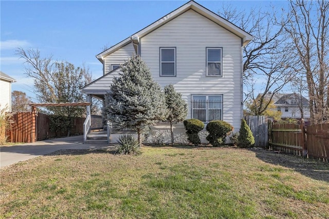 traditional home featuring a front yard, fence, and an attached carport