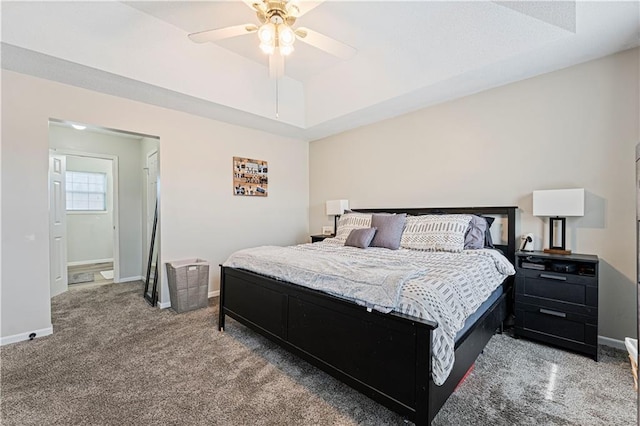 bedroom with a ceiling fan, baseboards, a tray ceiling, and carpet flooring