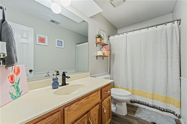 full bathroom featuring toilet, visible vents, wood finished floors, and vanity