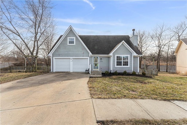 view of front of home featuring a garage, concrete driveway, fence, and a front lawn