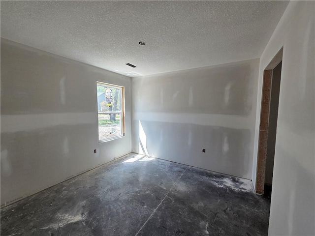 542 N Lexington St, Adrian, MO 64720 - spare room featuring concrete flooring and a textured ceiling