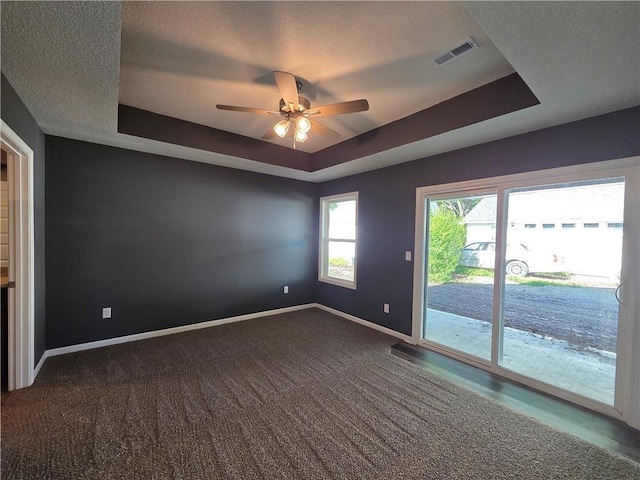 540 N Lexington St, Adrian, MO 64720 - carpeted spare room with a tray ceiling, baseboards, and ceiling fan