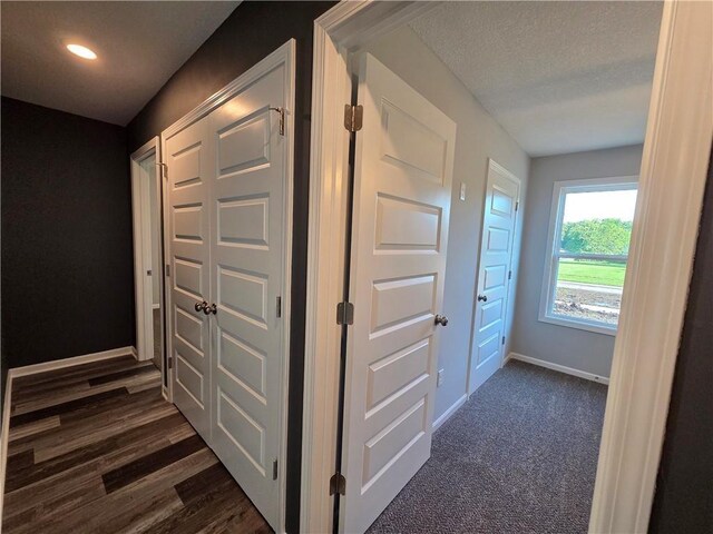 540 N Lexington St, Adrian, MO 64720 - corridor with baseboards, a textured ceiling, and recessed lighting