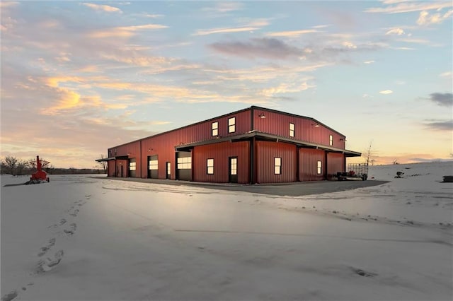 property at dusk with a detached garage