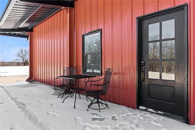 view of snow covered property entrance