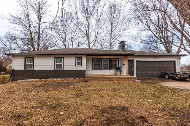 ranch-style home with a garage, concrete driveway, brick siding, and a chimney