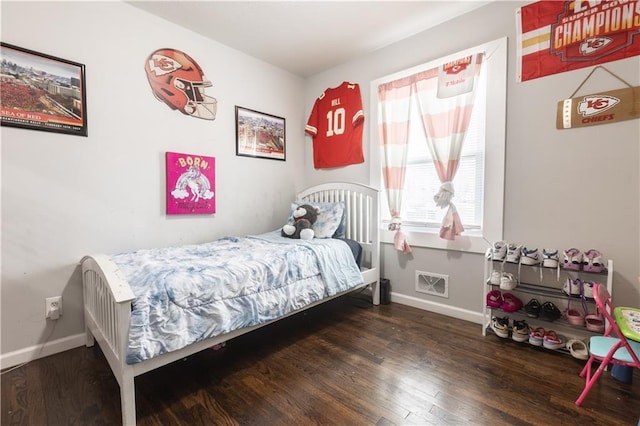 bedroom featuring dark wood-style floors and baseboards