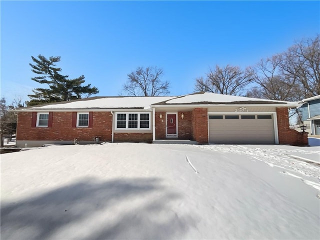 ranch-style house with brick siding and an attached garage