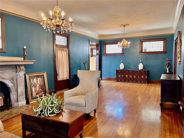 interior space with an inviting chandelier, crown molding, baseboards, and wood finished floors