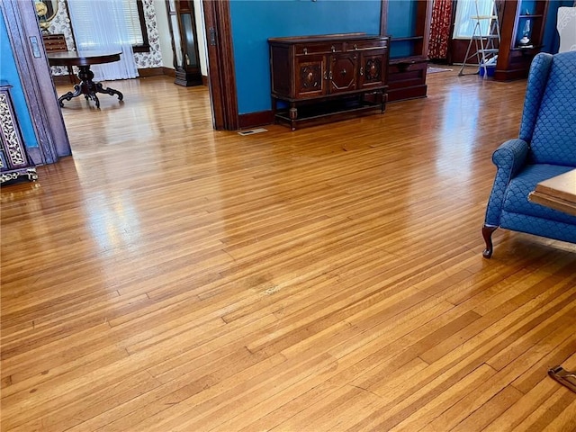 living area with visible vents and light wood finished floors