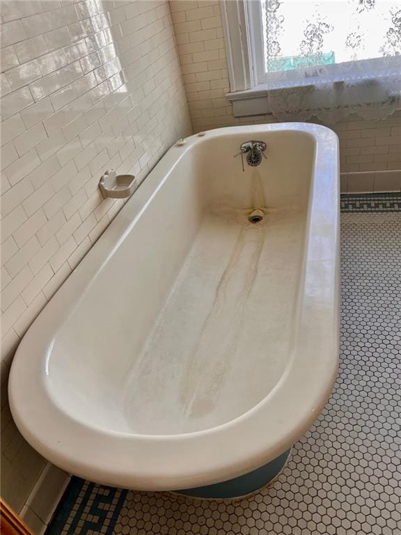 interior space featuring a freestanding tub and tile patterned floors