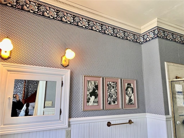 interior details featuring wainscoting and wallpapered walls