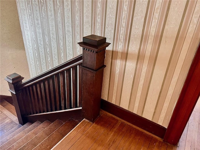 stairs featuring wood finished floors