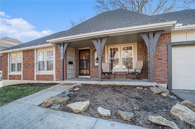 doorway to property with a porch, brick siding, a shingled roof, and a garage