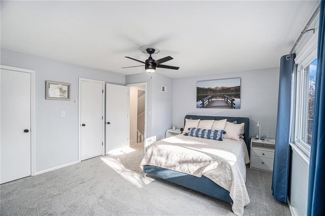 bedroom with carpet floors, ceiling fan, visible vents, and baseboards