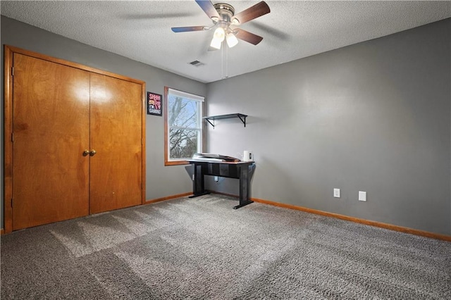 unfurnished bedroom with visible vents, baseboards, a ceiling fan, a textured ceiling, and carpet floors