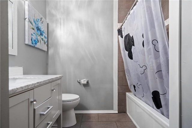 bathroom featuring shower / tub combo, baseboards, toilet, tile patterned flooring, and vanity