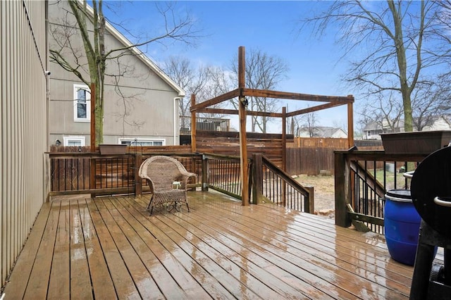 wooden deck featuring a fenced backyard