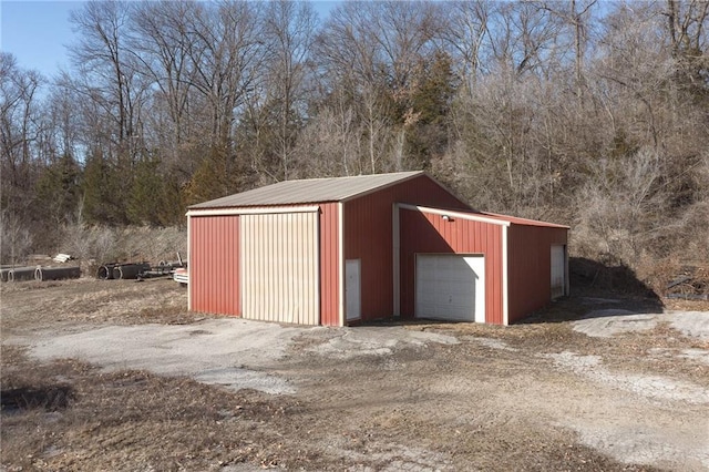 view of outbuilding with an outbuilding and dirt driveway
