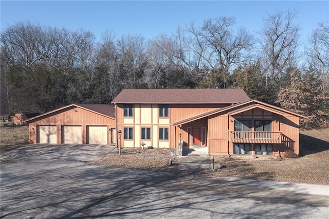 rustic home with aphalt driveway and an attached garage