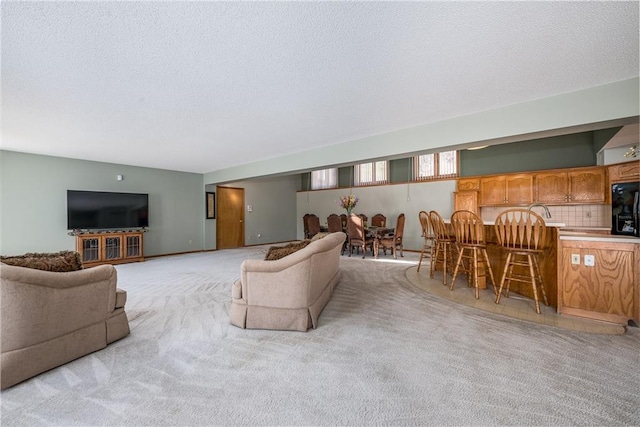 living room with indoor bar, light carpet, and a textured ceiling