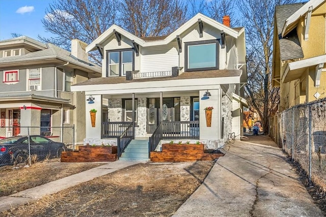 view of front of property with covered porch and fence