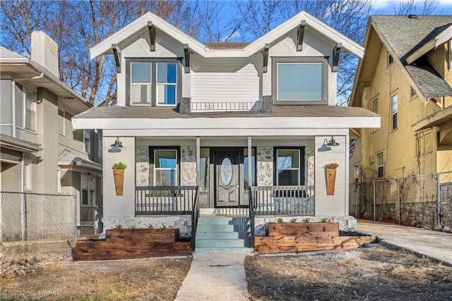 view of front of house with covered porch and fence