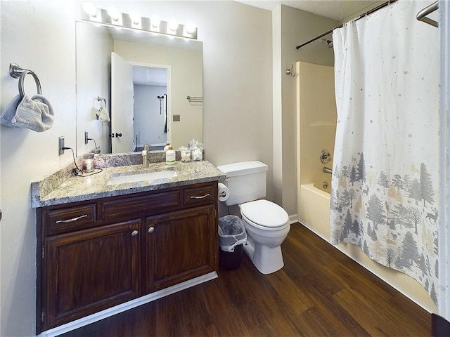 bathroom with toilet, shower / bath combo with shower curtain, wood finished floors, and vanity