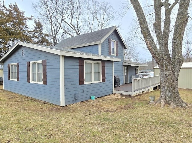 view of property exterior with a deck and a yard