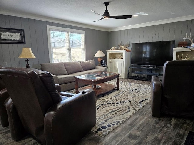 living room with ceiling fan, ornamental molding, and wood finished floors