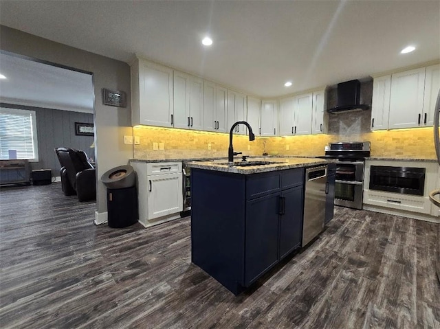 kitchen with range hood, white cabinetry, stainless steel appliances, and a sink