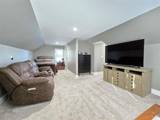 bedroom featuring lofted ceiling, light carpet, and baseboards