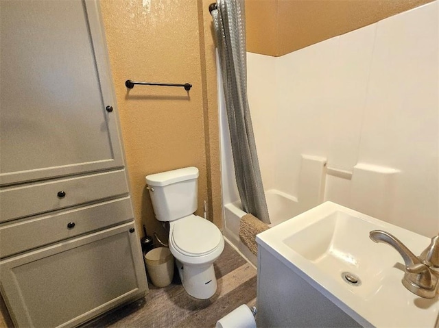 bathroom with vanity, toilet, and shower / bath combo with shower curtain