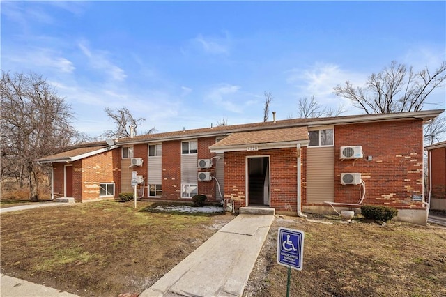 view of front of property with brick siding and a front lawn