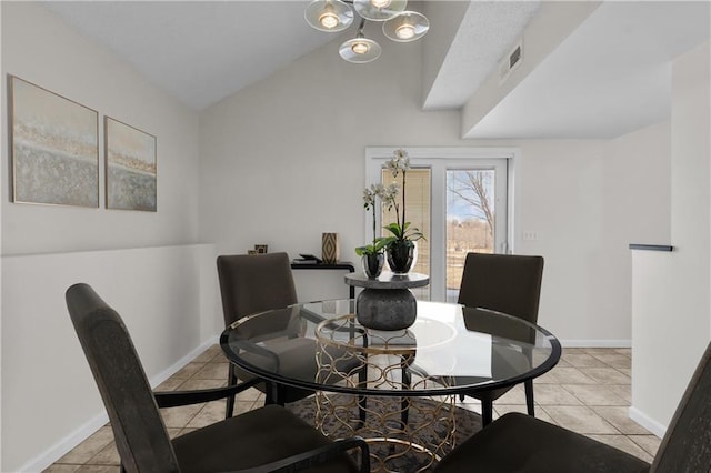 dining area featuring light tile patterned floors, vaulted ceiling, visible vents, and baseboards