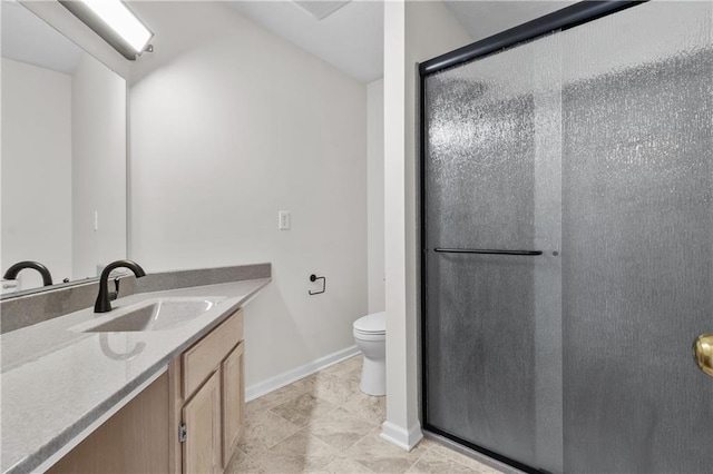 bathroom featuring baseboards, toilet, vanity, and a shower stall