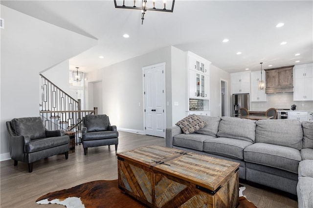 living area featuring recessed lighting, a chandelier, baseboards, and dark wood finished floors