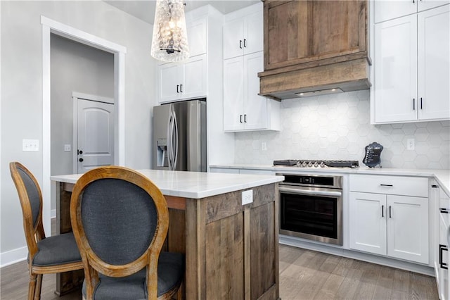 kitchen with white cabinetry, appliances with stainless steel finishes, and light countertops