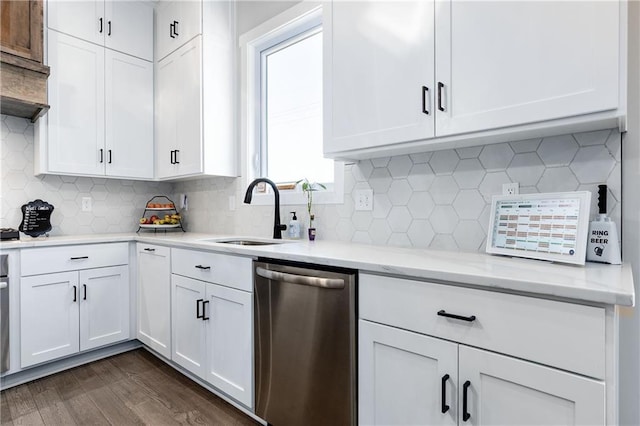 kitchen featuring light stone counters, dark wood-style floors, white cabinetry, a sink, and dishwasher