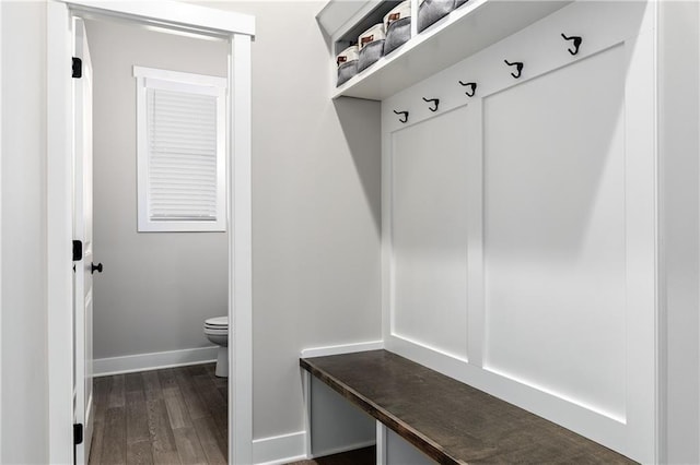 mudroom with dark wood-type flooring and baseboards