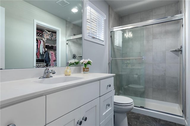 full bathroom featuring vanity, toilet, visible vents, and a stall shower