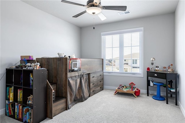 interior space featuring baseboards, visible vents, and ceiling fan