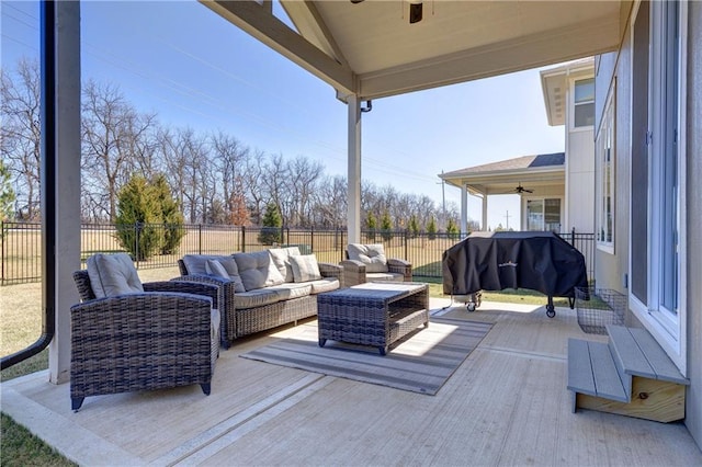 deck with outdoor lounge area, a ceiling fan, and fence